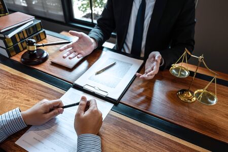 Professional male lawyer or counselor discussing negotiation legal case with client meeting with document contract in office, law and justice, attorney, lawsuit concept.の写真素材