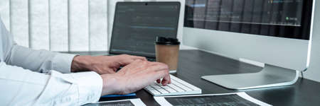 Young Programmer working in software javascript computer in IT office, Writing codes and data code...