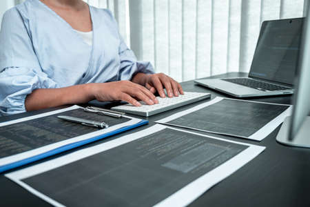 Female Programmer working in software javascript computer in IT office, Writing codes and data code...