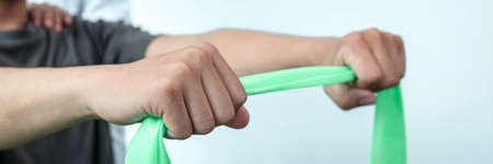Physiotherapist working examining treating injured arm of athlete patient, stretching and exercise,...