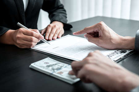 Businessman giving bribe money to businesswoman to bribing deal contract in a corruption, Illegal,...
