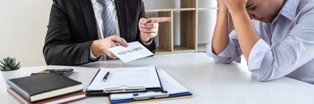 Business boss sending you're fired letter or final remuneration to layoff employee in order to...