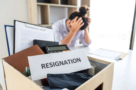 Stress of business woman employee intend to sending resignation letter to boss employer consider in order to contract for quit or layoff of job leaving from work, resignation concept.の写真素材