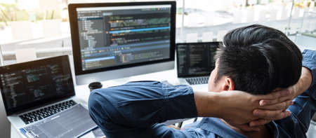 Developer programmer relaxing and looking project in software development computer in IT company...