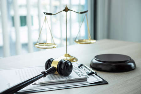 Judge gavel with Justice at law firm in background with legal case document contract, law and...