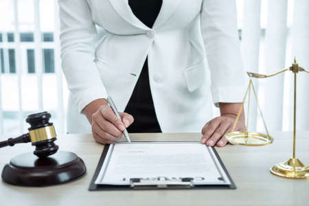 Female lawyer working with legal case document contract in office, law and justice, attorney,...