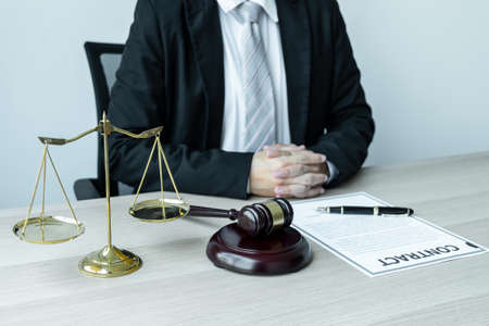 Male lawyer working with legal case document contract in office.の写真素材