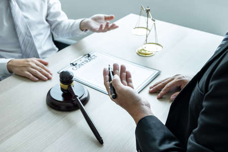 Professional Male lawyer or counselor discussing negotiation legal case with client meeting with document contract in office, law and justice, attorney, lawsuit concept.の写真素材