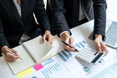 Two business partner team meeting and discussion financial project of investment ideas, presentation and analyzing marketing planning strategy of business making to growth profit and successful.の写真素材