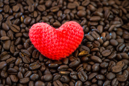 Red heart on coffee bean background
