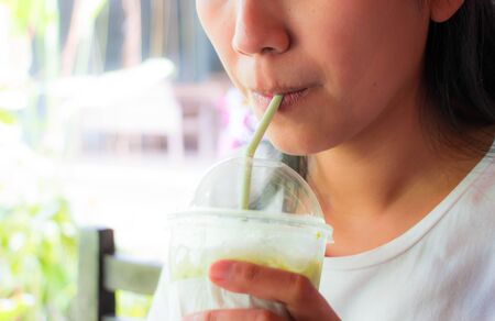 Women drinking ice green teaの写真素材