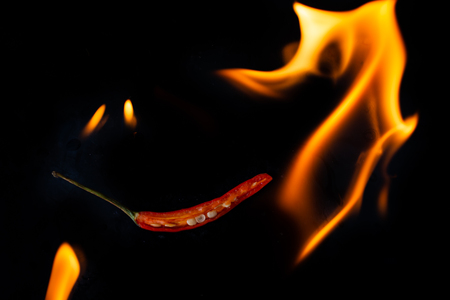 Burning chili on black backgroundの写真素材