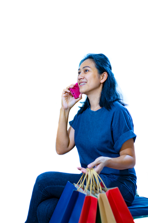 Asia women holding shopping bag on white backgrouの写真素材