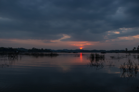 Sunset at the lake and rain stromの写真素材