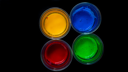 Acrylic color in a glass on black backgroundの写真素材