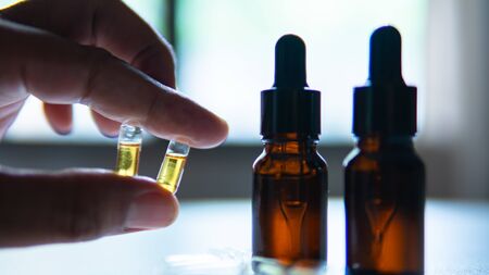 Hand holding marijuana oil in capsuleの写真素材
