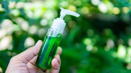 Hand holding perfume bottleの写真素材