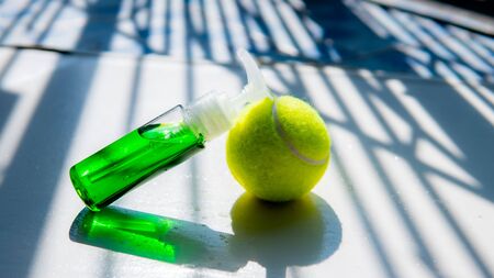Perfume bottle and tennis ball is sport cosmeticの写真素材