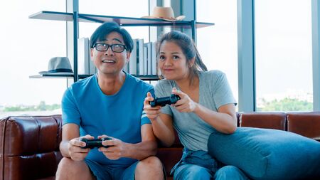 Old man and woman playing video gameの写真素材