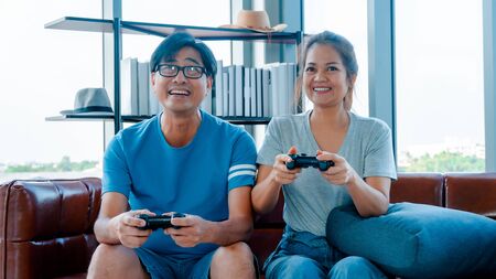 Old man and woman playing video gameの写真素材