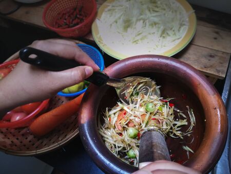 Thai papaya salad or what we call  Som Tum  in Thai with ingredients. The famous local Thai street food dish with the taste of hot and spicy.の写真素材