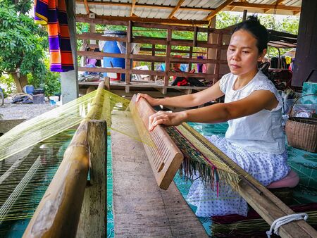 HDR image for made mat by loom. Woman live in the countryside making basketwork. Pallet is the wicker from jute.の写真素材