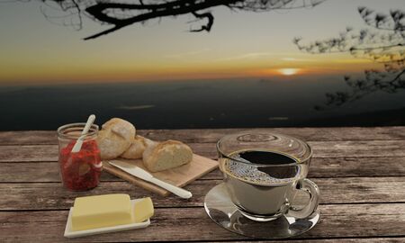 black coffee  in clear glass  and  Home made bread on butcher  for breakfast  concept on wooden...