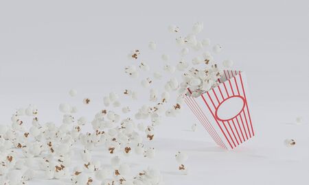 Popcorn in red and white striped cardboard bucket isolated on white backgroundの写真素材