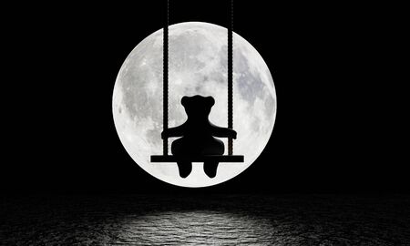 Silhouette of a teddy bear sitting on a swing There was a big rope hanging. The background image is a large moon shining with a reflection on the water surface or river. Sad and lonely. 3D renderingの写真素材