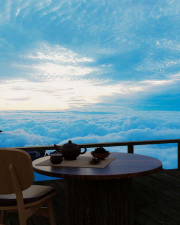 Ceramic tea set and dry tea leave on a wooden table and chair on the balcony or terrace made of...