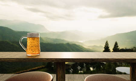 Draft or craft beer in clear glass with beer foam on top Put on set of wooden tables and chairs. Lounge seating on the wooden terrace with mountain background with god light or sunlight.3d renderingの写真素材