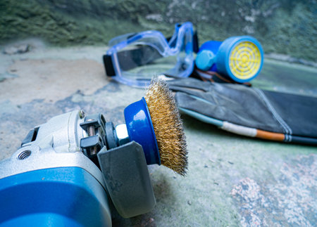angle grinder with brass wire brush head To scrub the wall surface and anti-dust equipment, goggles and leather gloves for the safety of the body.の写真素材