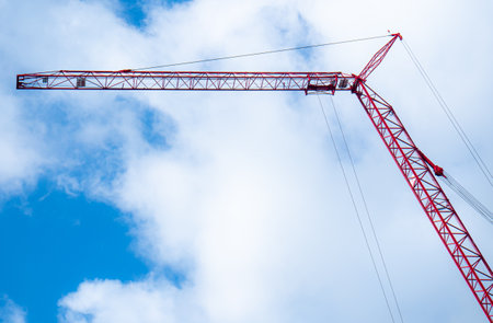 crane for construction Background with bright sky, white clouds. Tools for constructing tall buildings.の写真素材
