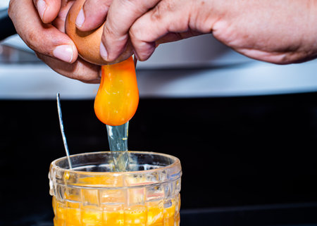 Crack the egg into the glass. poached eggs high protein food good for breakfast eat with coffeeの写真素材