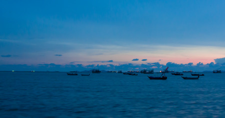 Fishing boat was moored Sea with Sunsetの写真素材