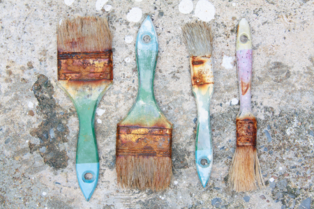Used paint brushes with size 63mm.(2-1/2 in) 25 mm(1 in) and 19mm.(3/4 in) on dirty floorの写真素材