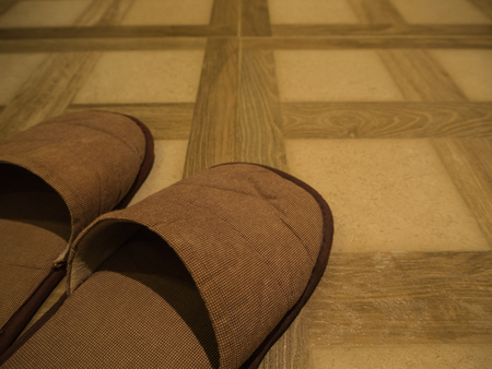 brown Slippers on tile floorの写真素材