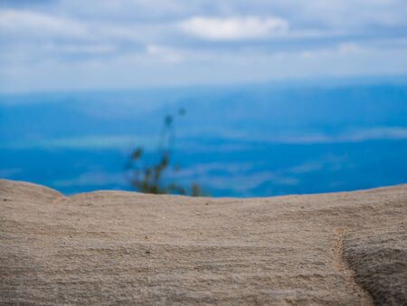 stone in front of abstract blurred blue sky backgroundの写真素材