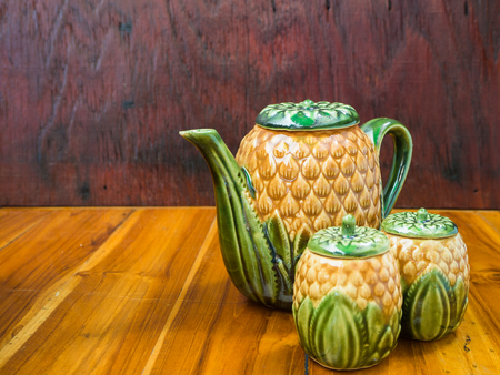 beautiful tea pot on wood tableの写真素材