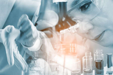 double exposure. scientist with microscope for chemistry biology test samples,examining liquid,laboratory glassware containing chemical liquid for design or decorate science or other your contentの写真素材