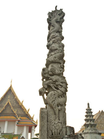 stone dragon pillar in front of thai templeの写真素材