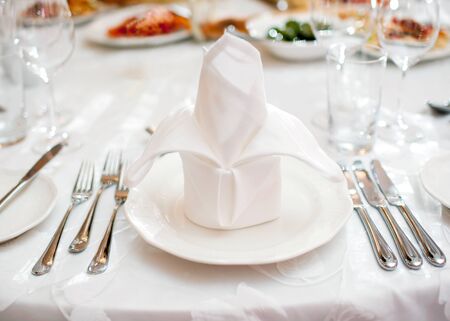Glasses and plates on table in restaurantの写真素材