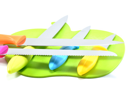 Five knives on the chopping block - White backgroundの写真素材