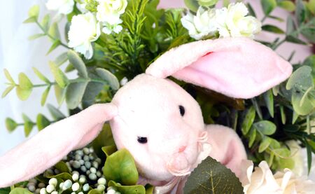 Rabbit in the rose artificial flowers bouquetの写真素材
