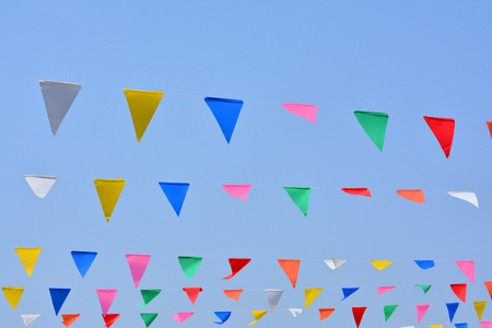 The colorful flag on blue sky backgroundの写真素材