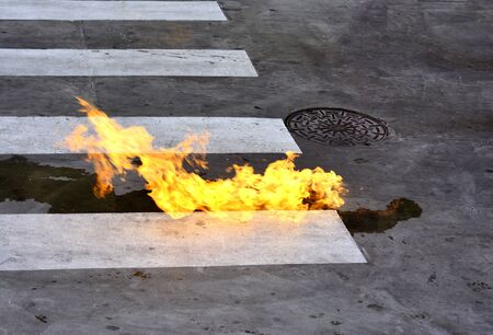 Fire from oil spill on the roadの写真素材