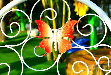 The red butterfly on white curved steel - select focus on butterflyの写真素材