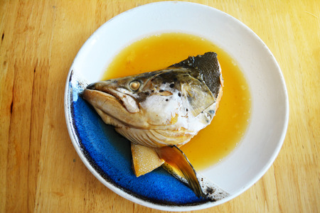 Salmon Kabutoni or Salmon head with sweet sauce on the white dish for japanese food backgroundの写真素材
