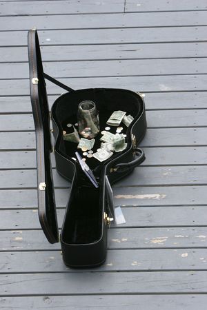 Guitar case of donated money for a performing guitaristの写真素材