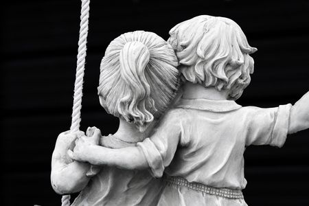 Statue of couple on swingの写真素材
